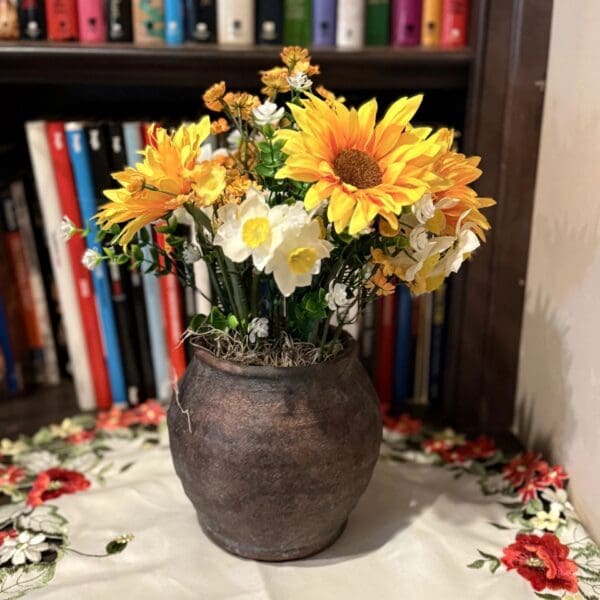 Sunflowers in rustic vase on table