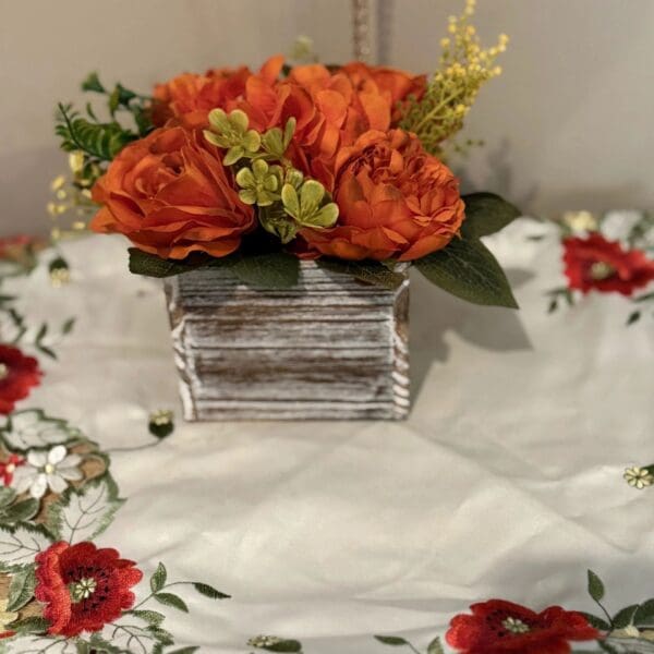 Floral centerpiece on embroidered cloth
