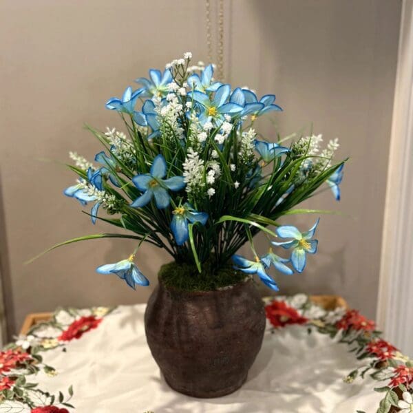 Elegant flower arrangement on embroidered tablecloth