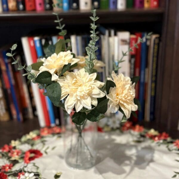 Flowers in vase with bookshelf background