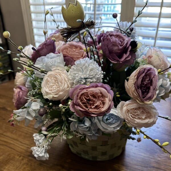 Colorful flower arrangement in a woven basket.