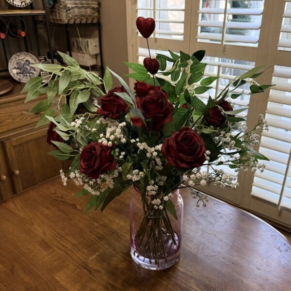 Bouquet of red roses in glass vase.