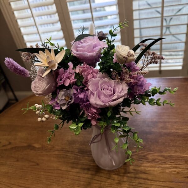 Purple floral arrangement in a vase indoors.