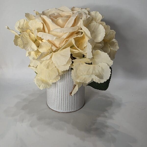 White flowers in a striped ceramic vase.