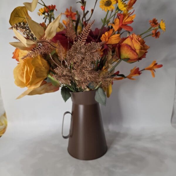 Brown vase with colorful autumn flowers arrangement.