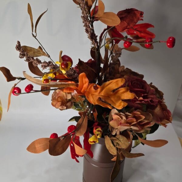 Autumn floral arrangement in a brown vase.
