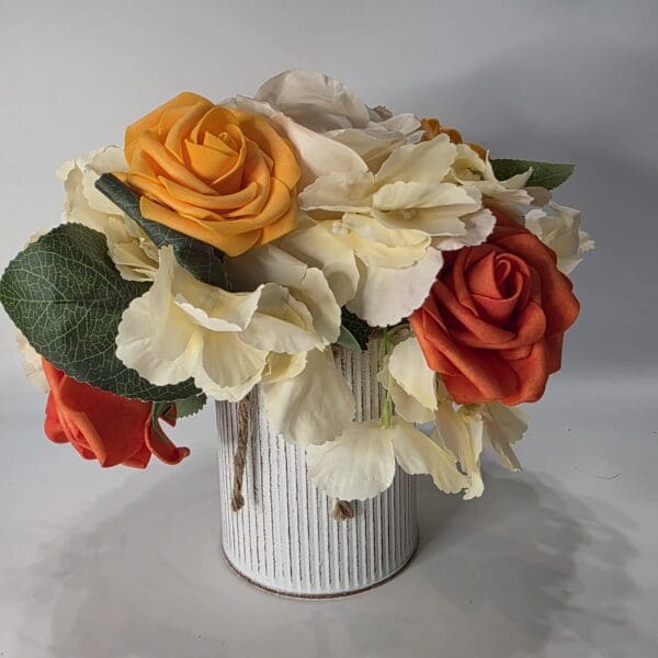 Bouquet of orange, yellow, and white flowers.