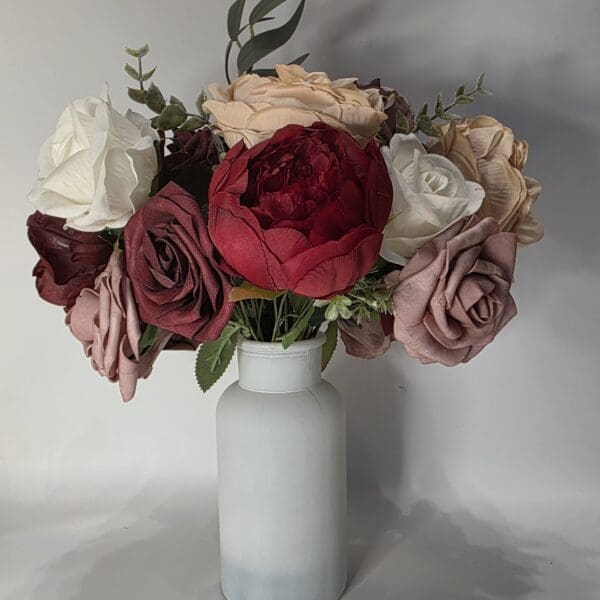 Flower bouquet in white vase.
