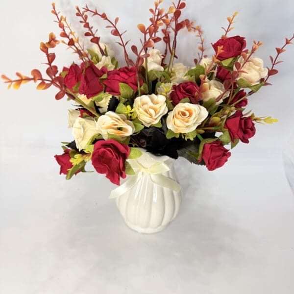 Vase with red and white roses arrangement.