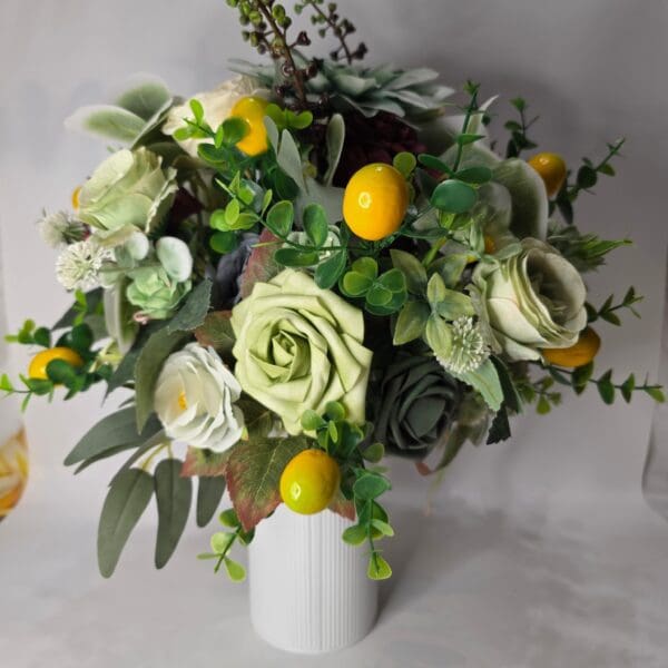 Bouquet with green roses and yellow accents.