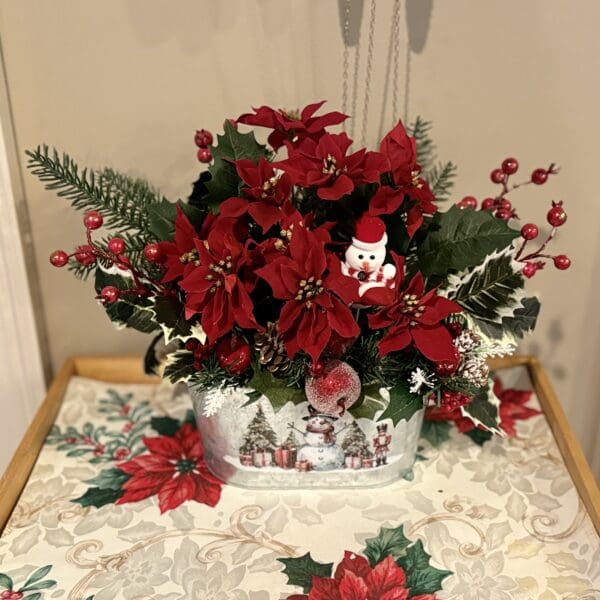 Festive floral arrangement with red poinsettias.