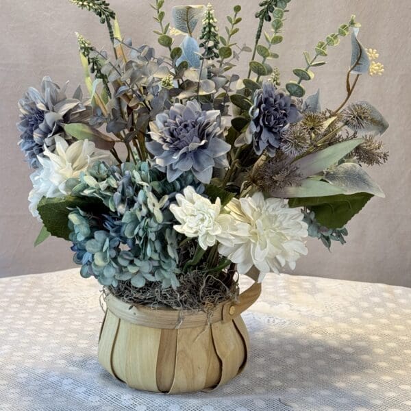 Blue and white bouquet in wooden vase