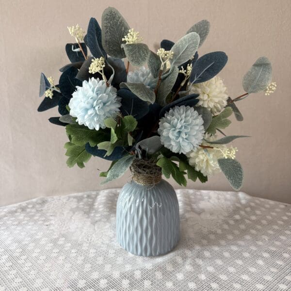 Blue and white floral arrangement in vase