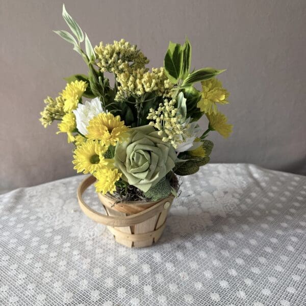 Yellow and green flower arrangement in basket