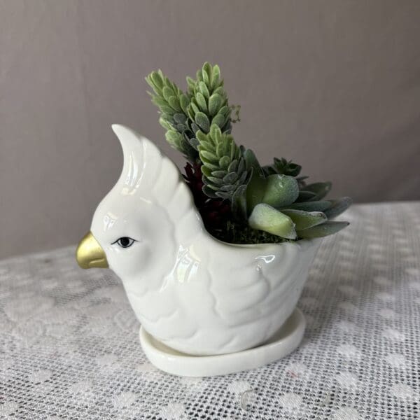 White bird planter with succulents
